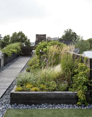 narrow garden ideas with zoned planting and seating on a roof terrace