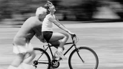 Man Pushing Woman on a Bicycle