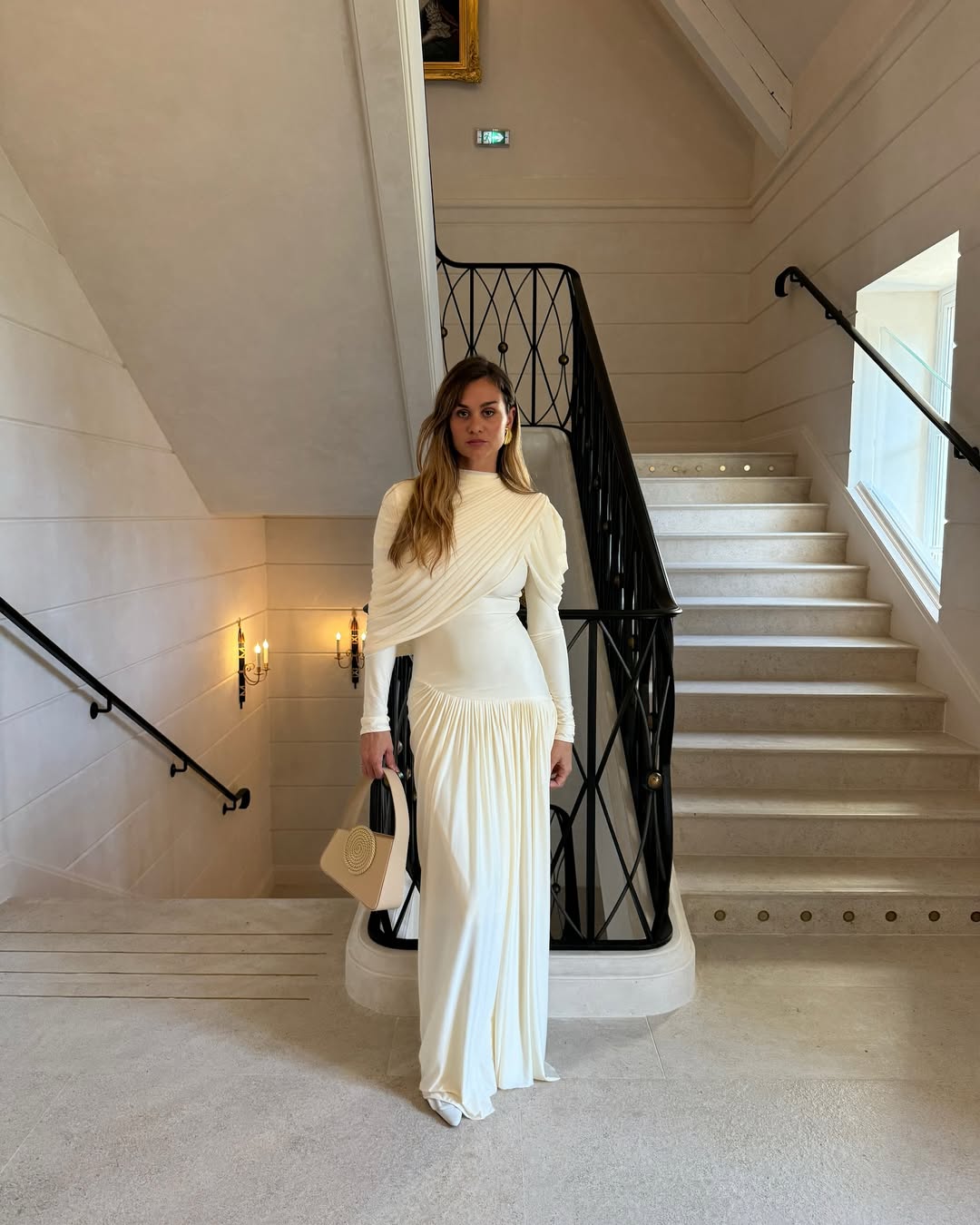 Anne laure mais wears a cream dress