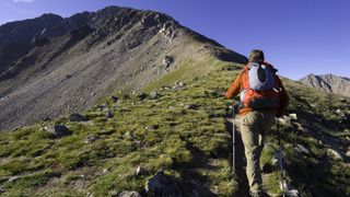 A man hikes up the ridge of a mountain in Colorado