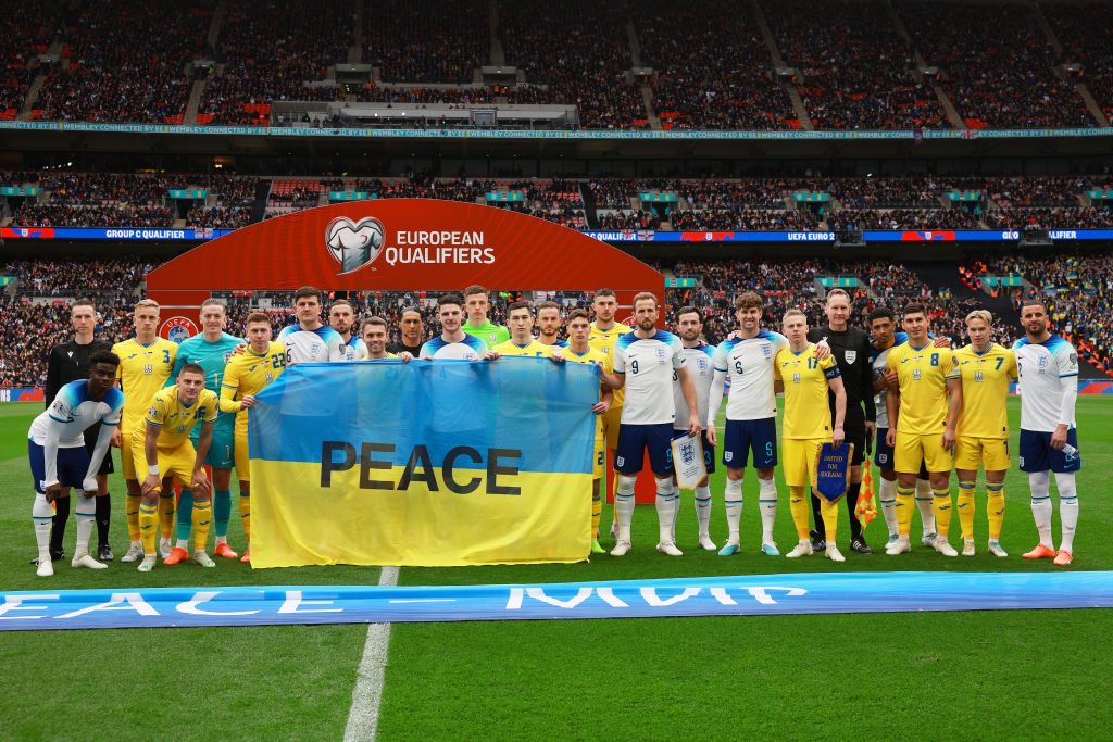 Players from both side&#039;s pose for a photograph with a Ukraine flag with the word Peace on prior to the UEFA EURO 2024 qualifying round group C match between England and Ukraine at Wembley Stadium on March 26, 2023 in London, England. (Photo by Eddie Keogh - The FA/The FA via Getty Images)