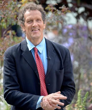Monty Don wearing a suit and tie while presenting