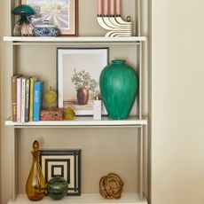 Living room open shelving with vases and decorative accessories.