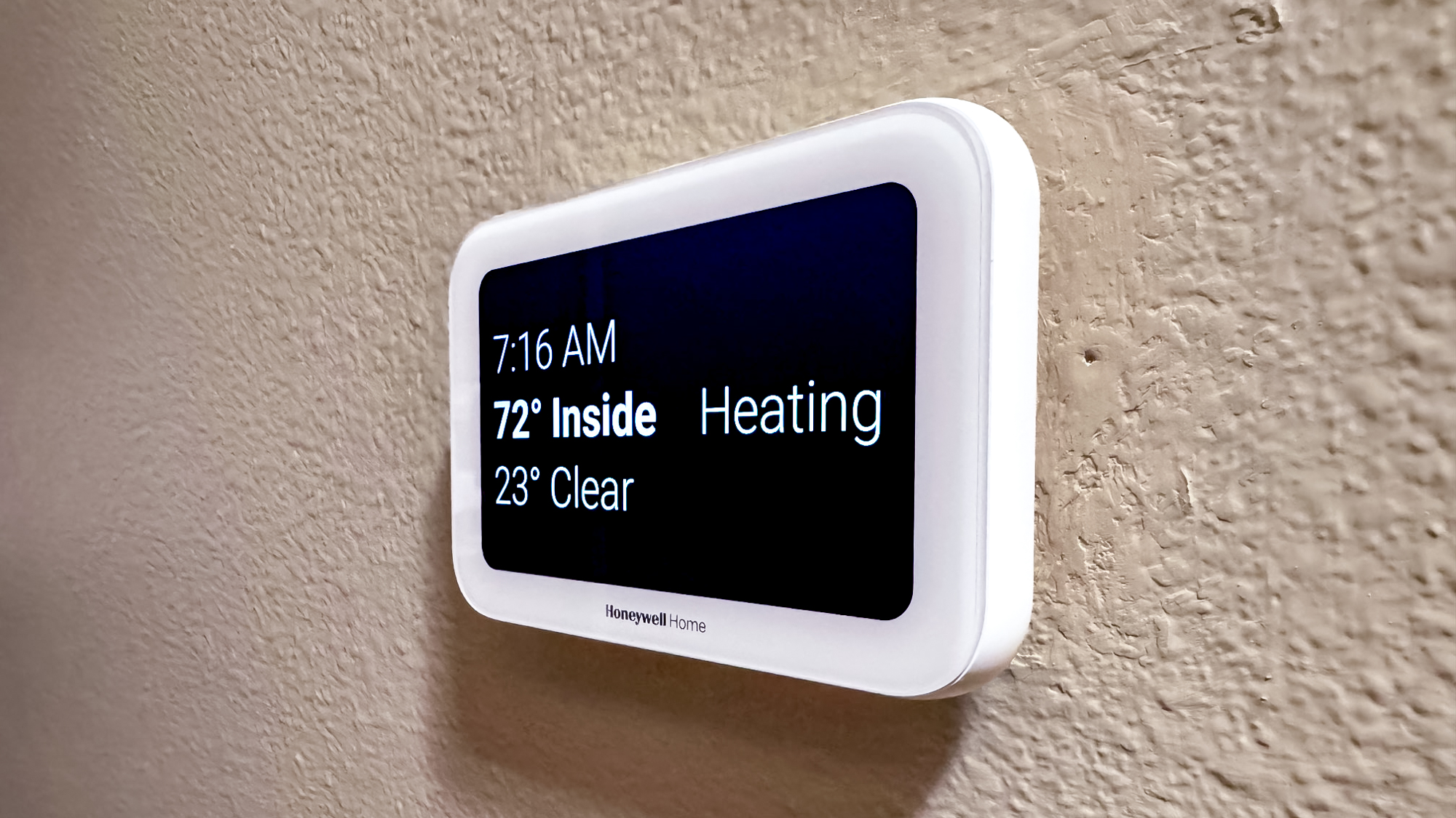Honeywell Home X8S Smart Thermostat mounted to a hallway wall