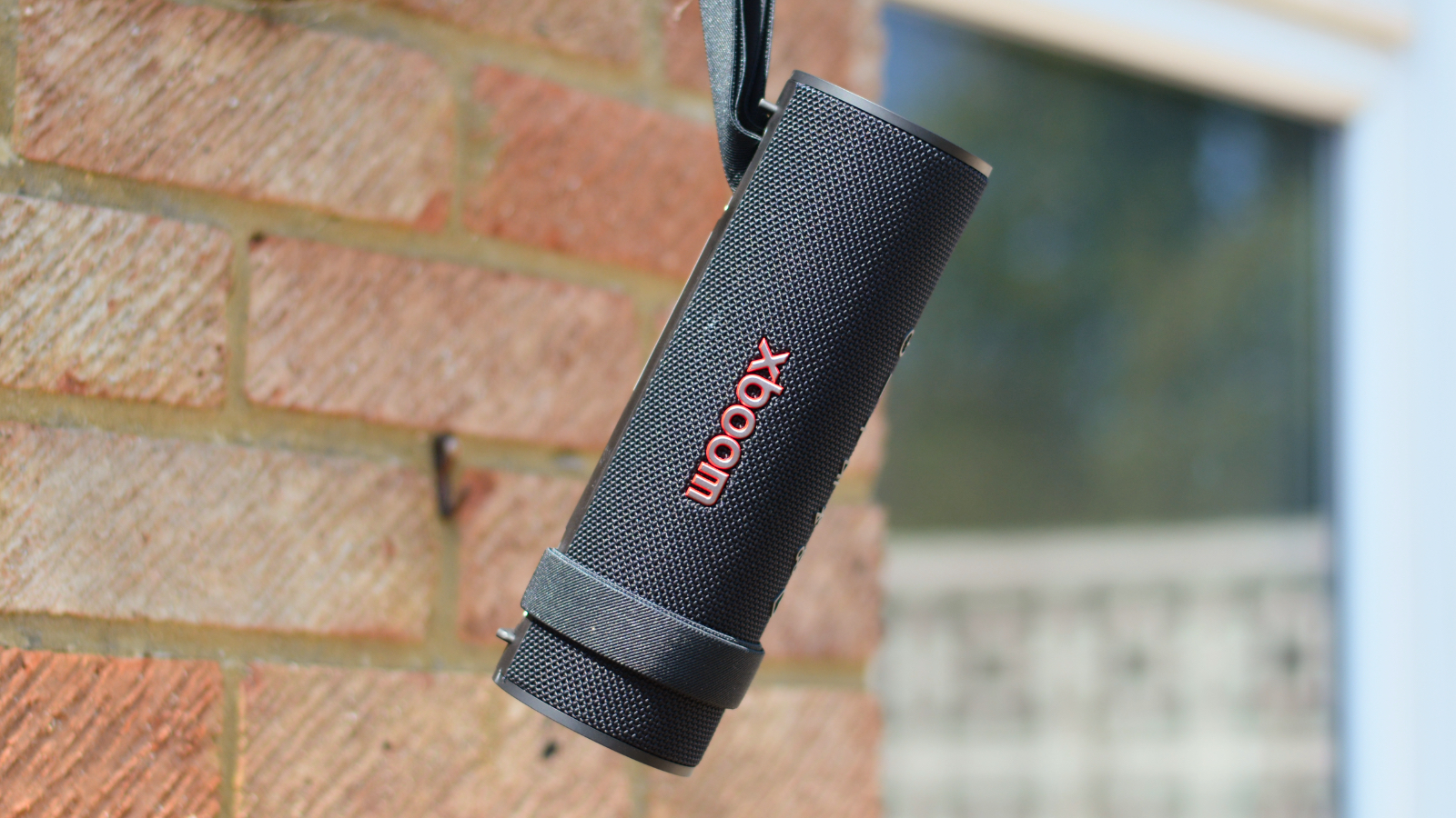 LG xboom Grab Bluetooth speaker in an outdoor setting