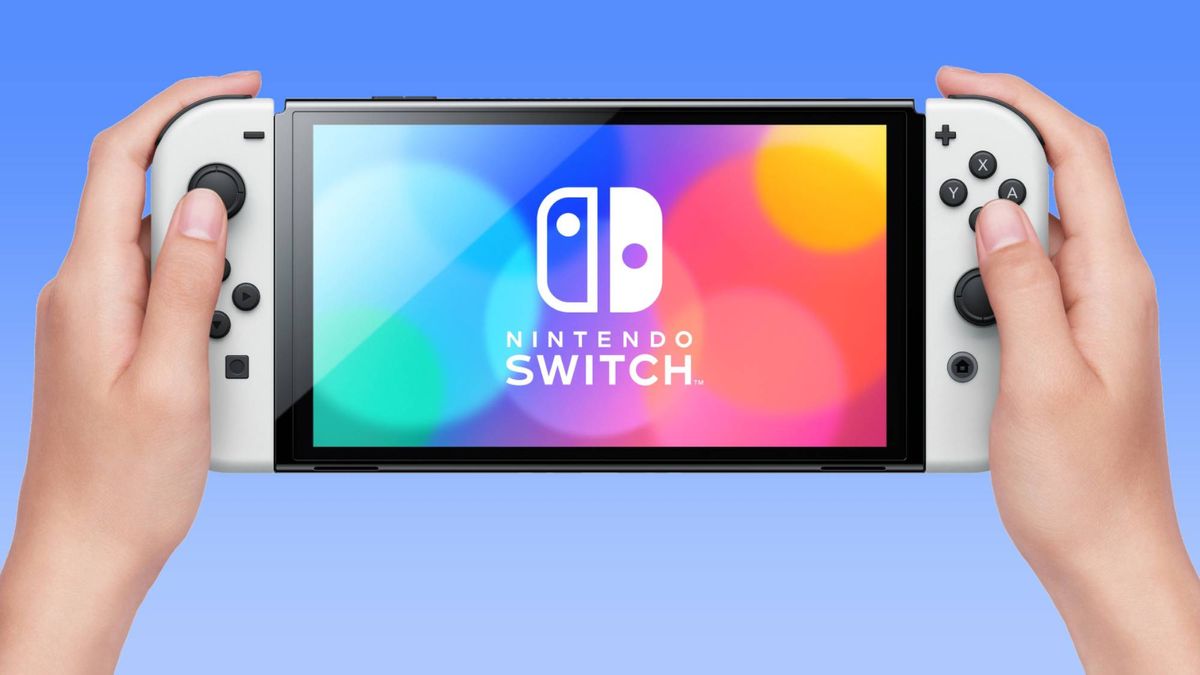 Woman holding white Nintendo Switch OLED console against white background