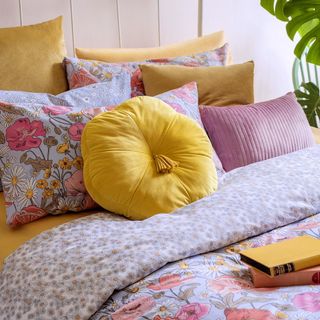 room with yellow cushion and pillows