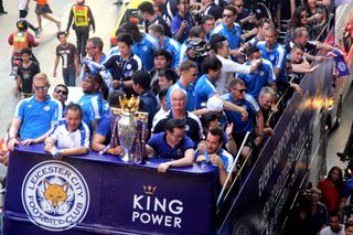 Leicester City's players and staff celebrate their Premier League title with the trophy on an open-top bus parade around the city in May 2016.