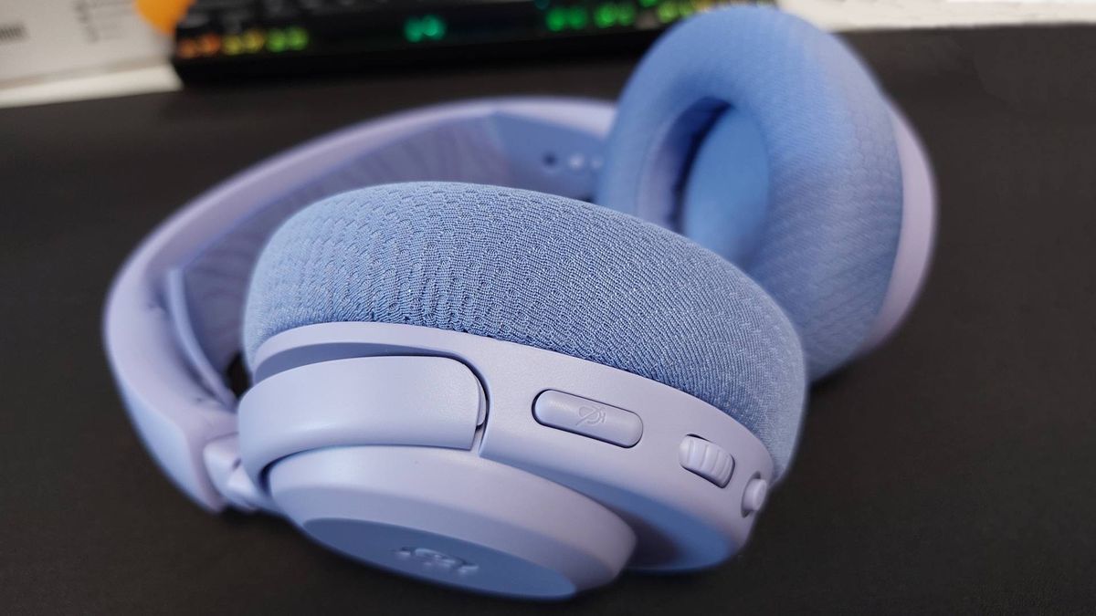 The SteelSeries Arctis Nova 3 X seen on a desk. This is the Lavender colourway.