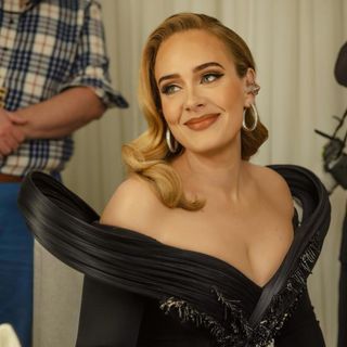 Adele backstage at her Weekends With Adele show wearing a sculptural gown and Old Hollywood waves