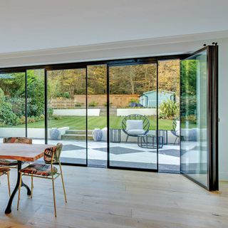 slide and turn doors leading to garden from dining room with wooden floor