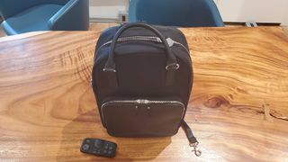 black laptop backpack sitting on a wooden table