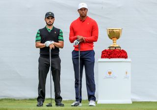 Abraham Ancer and Tiger Woods stand in front of the Presidents Cup