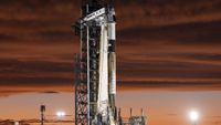 SpaceX's black and white Polaris Dawn Falcon 9 rocket stands on the launch pad in stunning twilight.