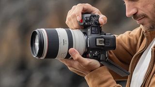 A man holding the Canon EOS R5 C camera in portrait