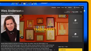 A laptop screen on a yellow background showing an IMDB page for Wes Anderson