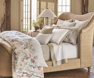 Ralph Lauren Elisabetta Bed Linen on a sleigh bed frame against beige walls.