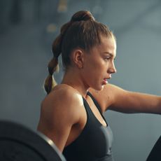 A woman trying low intensity strength training at the gym