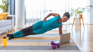 Woman performs side plank core exercise