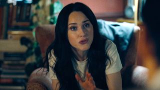 Rachel Brosnahan sits gesturing in conversation as she interviews David Corenswet in Superman (2025).