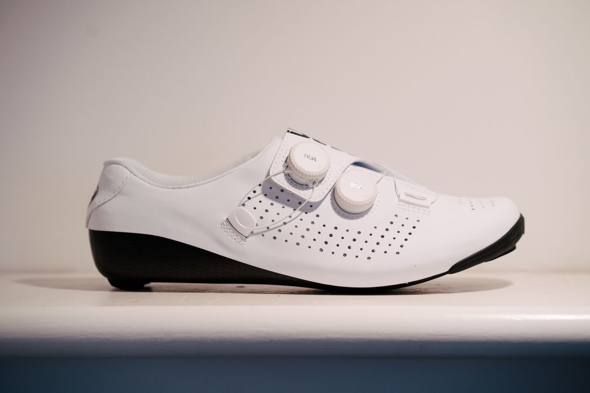 A white bicycle shoe on a shelf