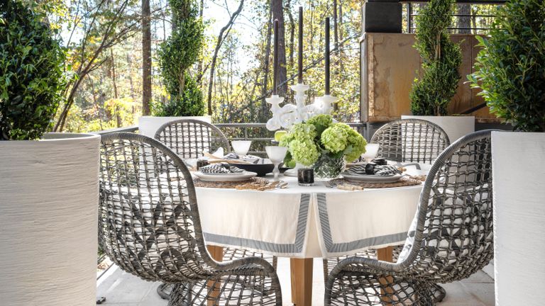 an outdoor dining table on a porch
