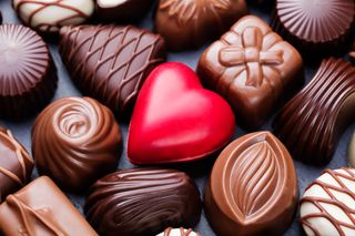 closeup of an array of fancy chocolates, including a red chocolate heart