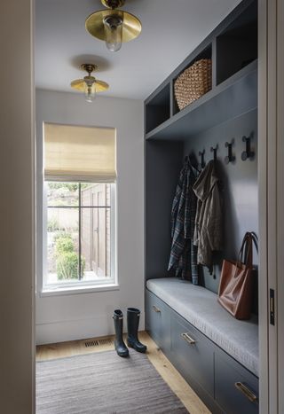 small blue entryway with builtin storage by Lisa Staton