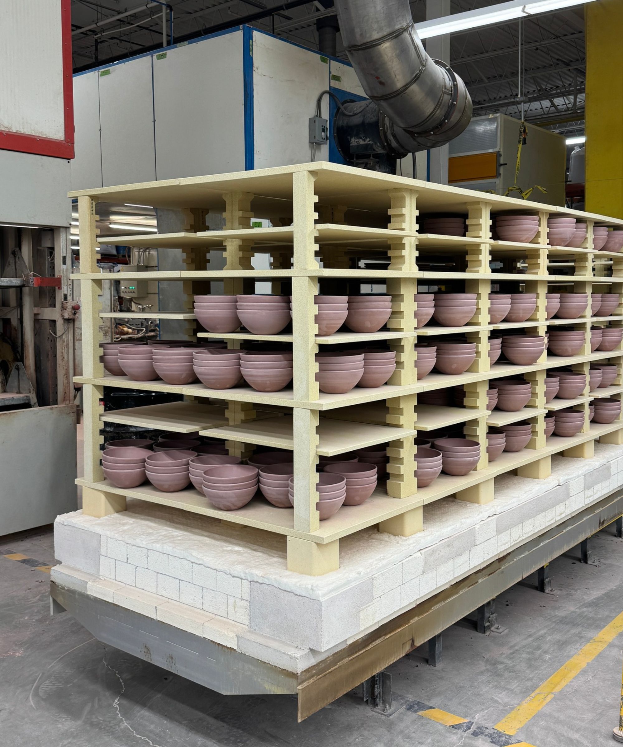 Pottery factory with terracotta bowls piled high on shelves
