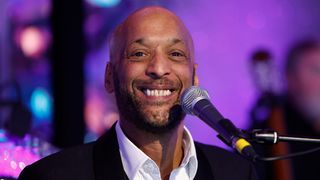 Tommy Blaize - Strictly Come Dancing singer smiling with a microphone 