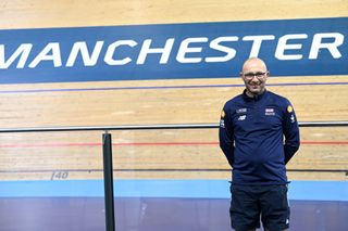 Stuart Blunt smiling while standing in Manchester velodrome