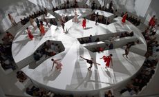 An aerial shot of a circular exhibition space featuring a performance of Once With Me, Once Without Me