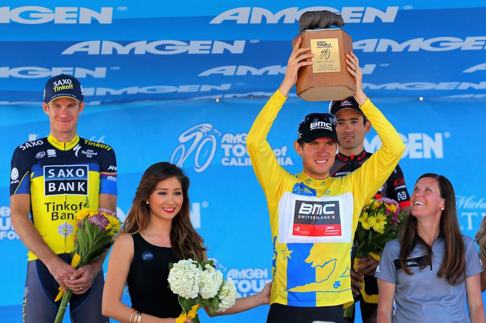 Tejay van Garderen of the USA riding for BMC Racing hoists the winners trophy presented by Kristin Bachochin (R) Executive Director and SVP of AEG on the podium following Stage Eight as he won the overall race leader's jersey of the 2013 Amgen Tour of California.