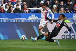 Angers French defender Enzo Ebosse (R) fights for the ball with Lyons midfielder Malo Gusto (L) during the French L1 football match between Olympique Lyonnais (OL) and Angers (SCO) at the Groupama Stadium in Decines-Charpieu, central-eastern France on April 3 2022.