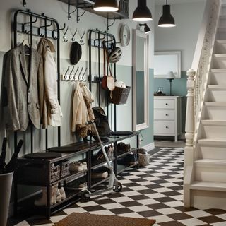 Ikea shoe racks, benches and coat hooks used in a hallway as a shoe storage idea