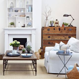 living room with white show case and fireplace and wooden table and white sofa chair