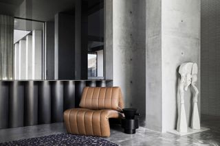 grey interiors with brown chair at Colonnade House by Splinter Society