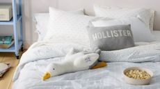Coastal cool college form room bedscape layered with striped and seagull-motif sheets from the new Hollister x Target bedding collaboration