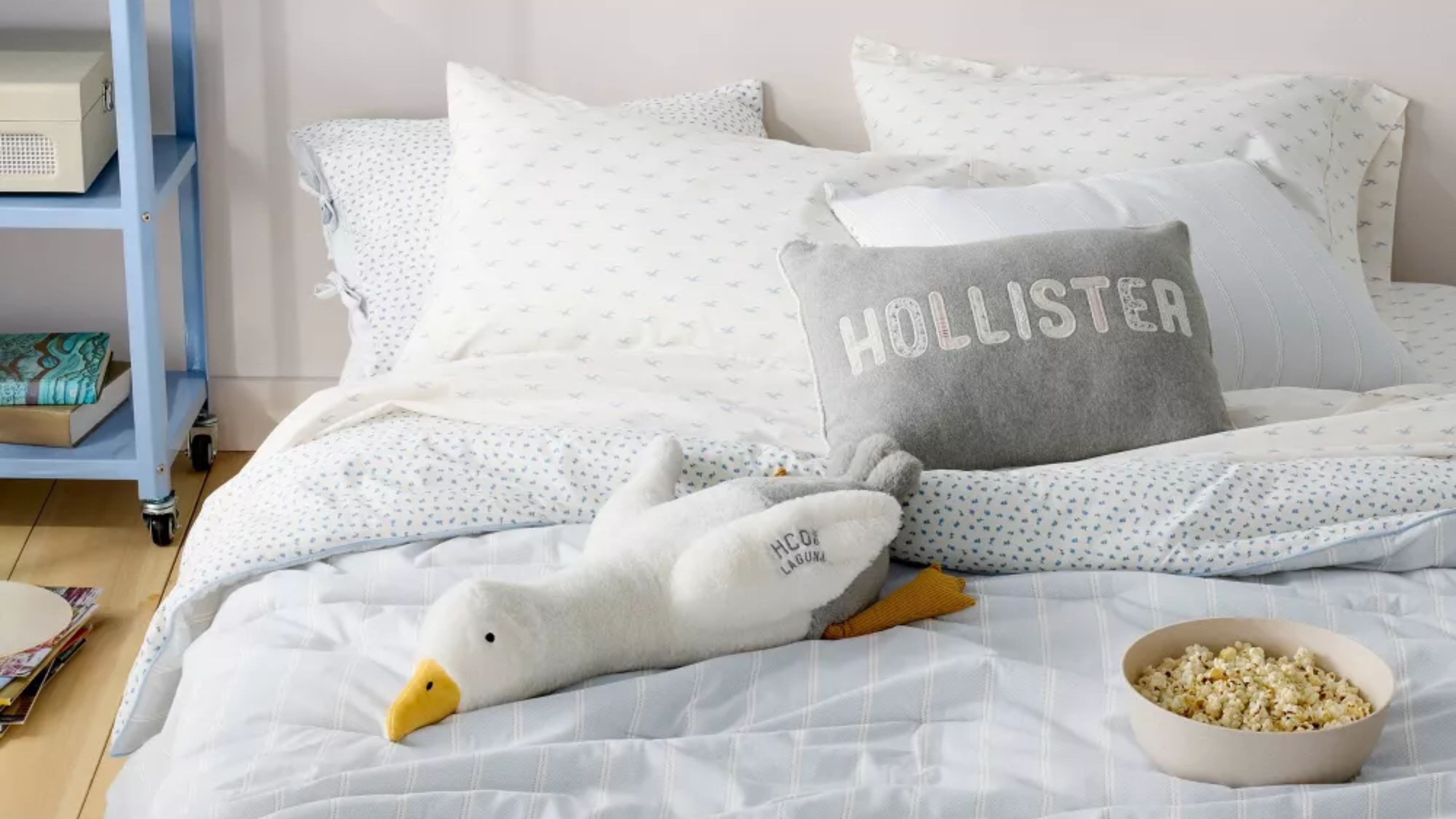 Coastal cool college dorm room bedscape layered with striped and seagull-motif sheets from the new Hollister x Target bedding collaboration