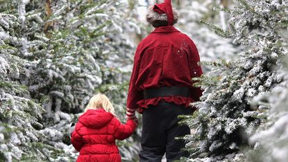 A young girl is taken to visit Santa Claus at Lapland UK
