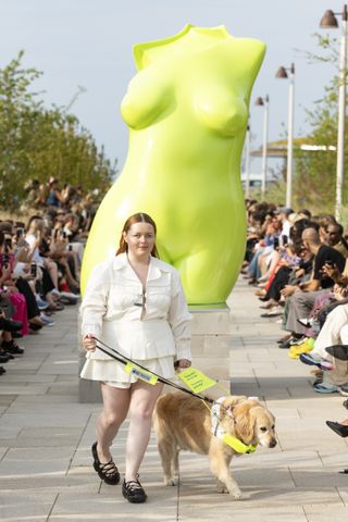 a model on the sinead odwyer runway with her guide dog