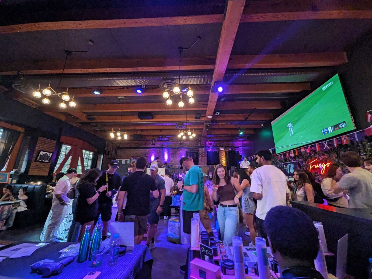 A dimly lit bar with a lot of people
