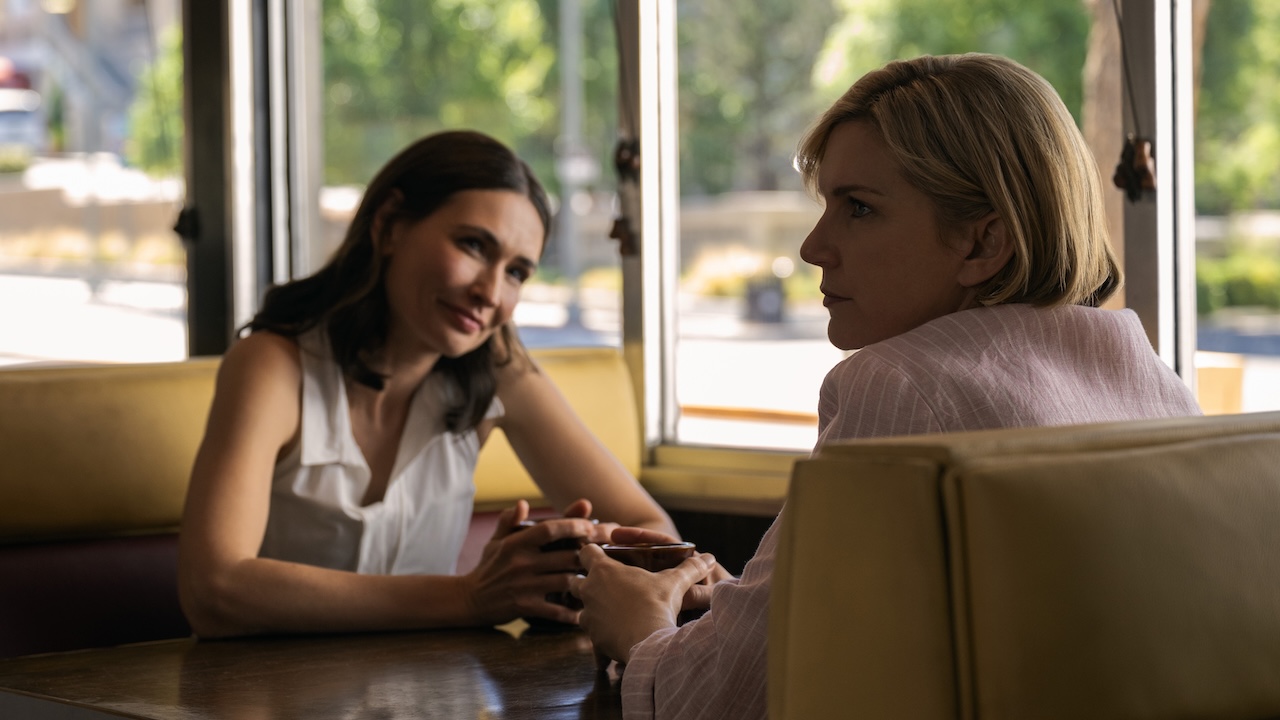 Zosia smiling at Carol while sitting in diner booth in Pluribus Season 1