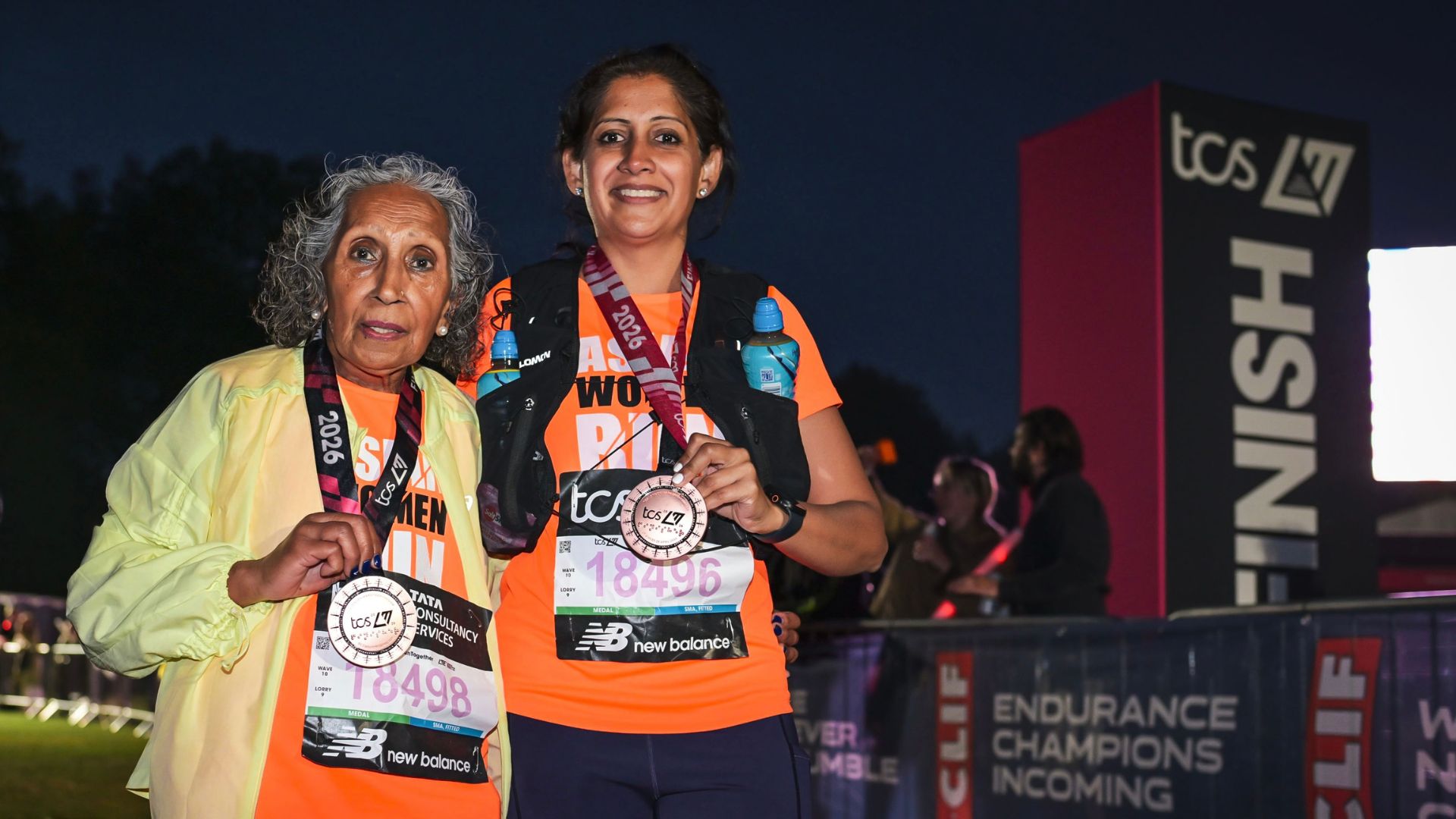 Minreet Kaur standing at the finish line with her Mum, holding London Marathon 2026 medals