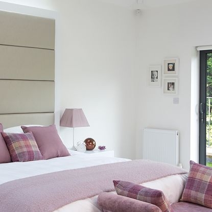 bedroom with side table and purple wall
