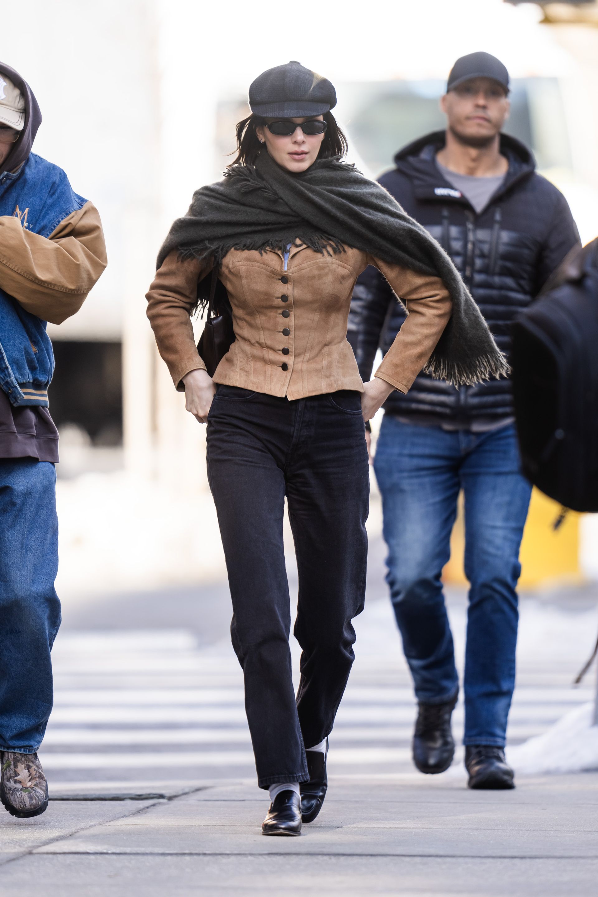 Kendall Jenner wears a suede jacket, straight leg jeans and loafers.