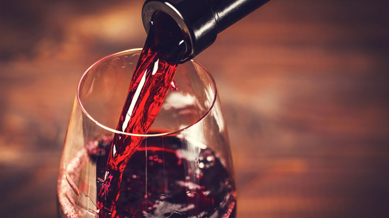 Red wine poured into a glass