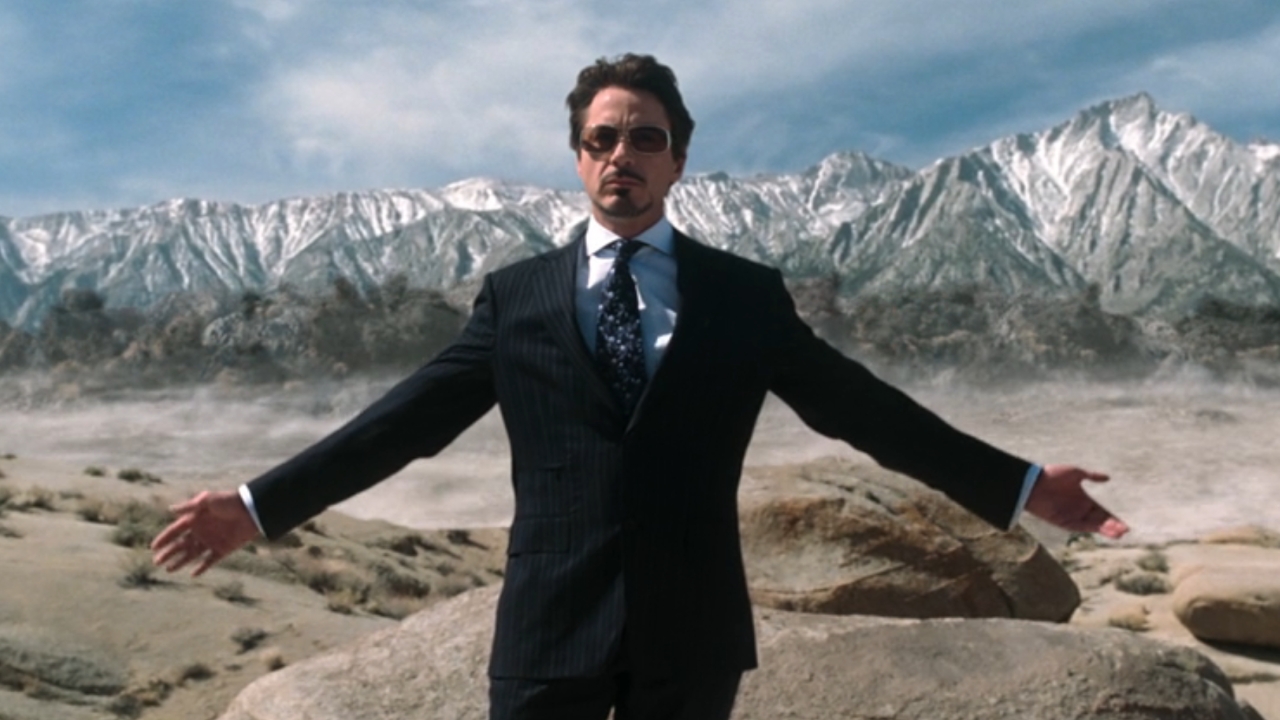 Tony Stark standing in front of explosion in Iron Man