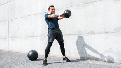 A man performing a kettlebell swing