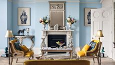 A traditional living room with light blue wall paint decor and framed wall art